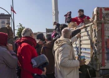 Volunteers on an NGO truck distributes clothing donations in Turkey. (Photo/Bloomberg)