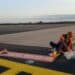 Members of German activist group Letzte Generation stick themselves to the tarmac at Hamburg Airport.