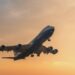 A Silk Way West Airlines plane flies in the dusk