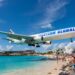 A Western Global plane flies over a beach